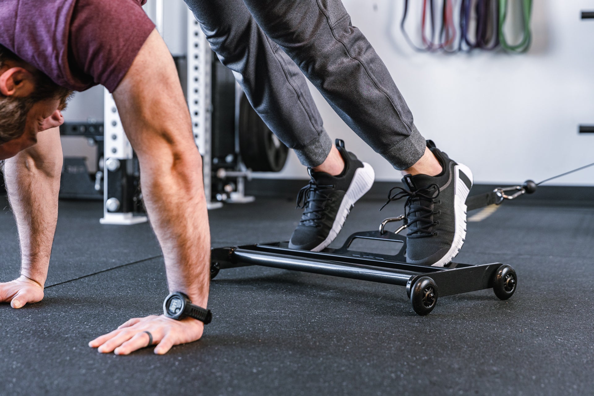 athlete using glute ham roller for ab exercises with strap attached to a functional trainer